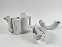 Front view of teapot, cups and candle holder