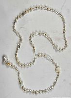 Full view of pearl and bead necklace showing length and missing clasp