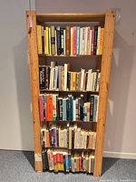Full view of loaded wooden bookshelf