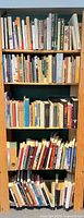 Front view of wooden bookshelf filled with books