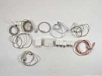 Full lot overview showing seven power bricks and eight Lightning cables