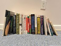 All 19 baseball books standing upright showing spines