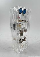 Side view of acrylic stand showing multiple rows of earrings attached