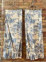 Full view of both curtain panels hanging to show length, width and pattern