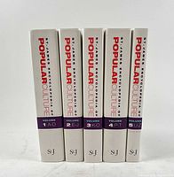 Spine view of all five volumes standing upright