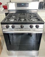 Full view of Samsung stainless steel gas range showing cooktop, knobs and oven door
