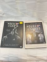 Front covers of both House of Cards DVD box sets