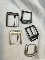 All six metal belt buckles displayed on cloth