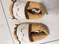 Tan/white plush slippers top view showing design and color