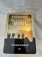 Front view of metal tin showing title Trenches Battleground WWI
