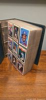 Binder standing open showing pages filled with 1989 Topps cards