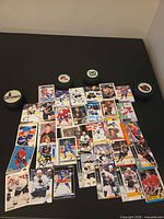 layout of approximately 30 hockey cards and four logo pucks