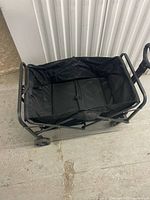 Cart open, view of interior fabric basket and steel frame