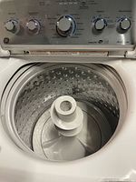 Open lid view showing stainless drum and agitator