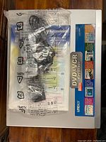 Top view of recorder with manual, remote, and cable sealed in plastic