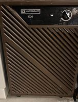 Front view showing grille, control dial and branding