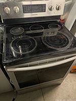 Front view of Samsung electric range showing glass cooktop and oven door