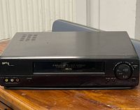 Front view of Sharp VC-H943U VCR on wooden surface