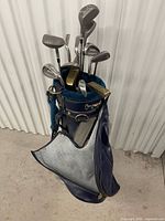 Top view of golf bag showing teal liner and mixed clubs (woods, irons, putter)