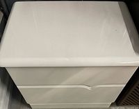 Top view of white nightstand showing glossy surface