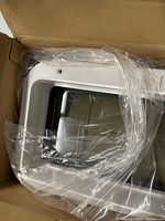 Portlight in box with protective plastic wrapping