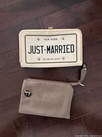 Front view of both purses showing license plate design and T logo