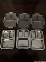All items: three lidded plastic Tupperware divided containers and three stainless steel compartment trays