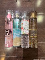 Front view of four Bath & Body Works fine fragrance mists showing labels and fill levels