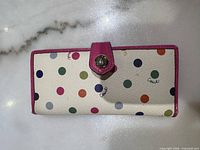 Front exterior showing polka-dot design, pink trim, metal snap