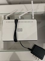 Front/top view of D-Link DIR-655 router with two antennas visible and power cable draped