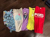 Five girls tops laid out side by side