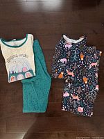 Both pajama sets laid flat showing tops and pants