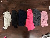 Six shirts laid flat showing colours and styles