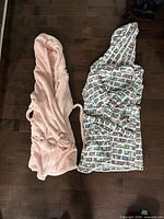 Both bathrobes laid flat showing colour, pattern, hoods and belts