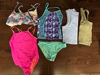 All six garments laid flat displaying fronts