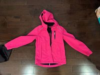 Front view of pink hooded winter coat with zipper and chest pocket