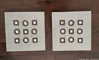 Both matching silver fabric square wall art panels with 3×3 grid of mirrored accents