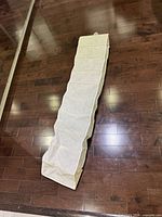 Full view of white fabric hanging shoe organizer laid flat