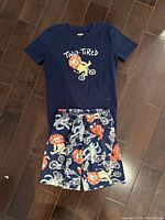 Full view of pajama top and shorts laid flat