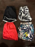 Four pairs of girls athletic shorts arranged flat to show colors and patterns