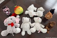 Group shot of all ten stuffed animals arranged on floor