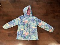 Front view of pastel swirl hooded winter coat laid flat