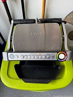 Closed view showing T-fal lid, control panel, doneness indicator knob, drip tray