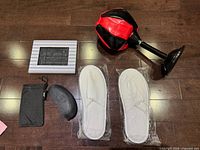 Lot overview showing slippers, two sunglass cases, picture frame, desktop punching ball
