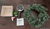 Overview of all six items in lot: wreath, saucepan, basket, sign, plush dog, potted succulent