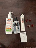 Group shot of lotion bottle, sinus rinse bottle, pore vacuum, four suction heads, and user manual