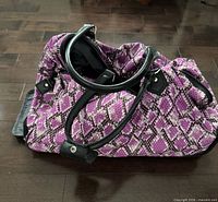 Top view of purple patterned rolling duffle bag with carry handles