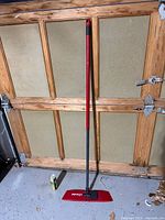 Full view of Vileda floor mop leaning against garage door