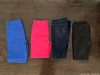 Four pairs of folded women’s pants laid side by side