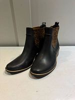 front view of both boots showing black upper and cheetah side panels
